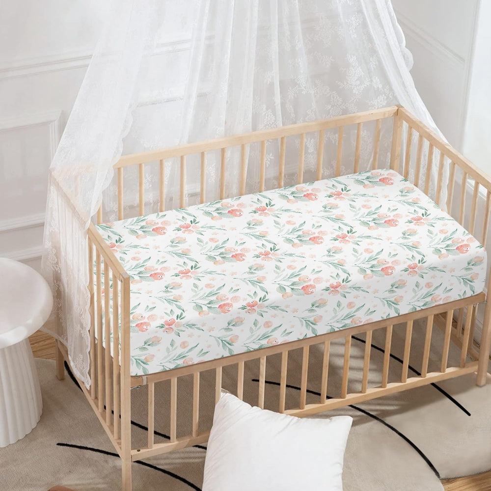 Winpema pink floral crib sheet showing secure fit on standard crib.