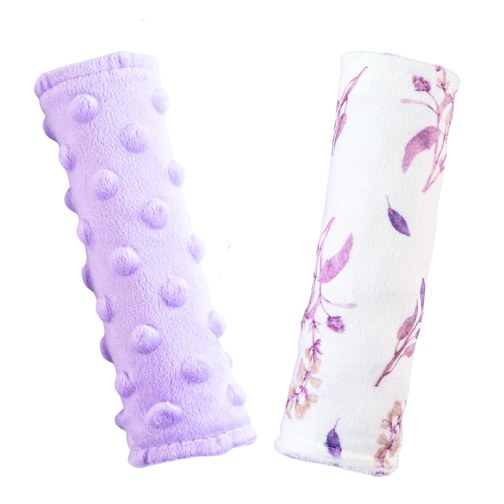 Wirein purple floral carseat strap cover on baby's shoulder reduces chafing during travel