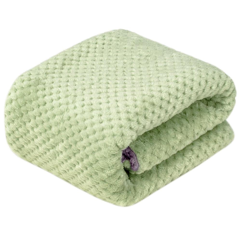 Wonder Miracle fuzzy sherpa blanket placed in a crib for all-season warmth.