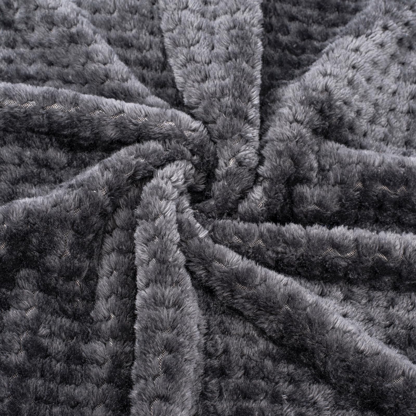 Dark grey Wonder Miracle blanket draped over a sleeping baby.