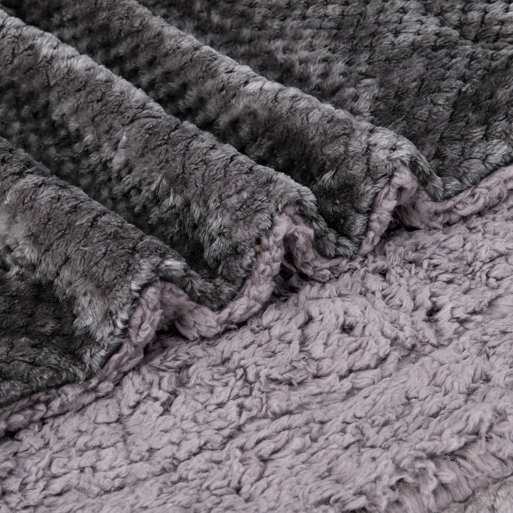 Travel-friendly Wonder Miracle blanket folded beside a bag demonstrates easy packing.