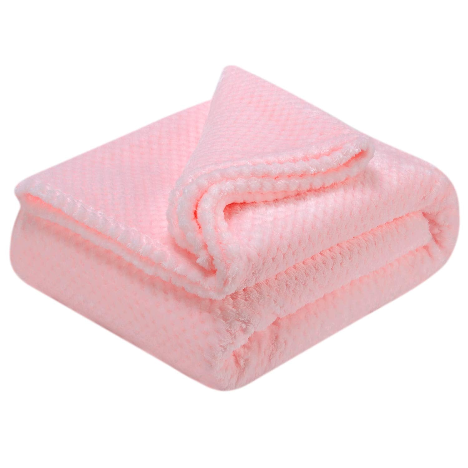 Wonder Miracle fuzzy throw blanket in baby pink folded beside cushions for versatile home comfort.