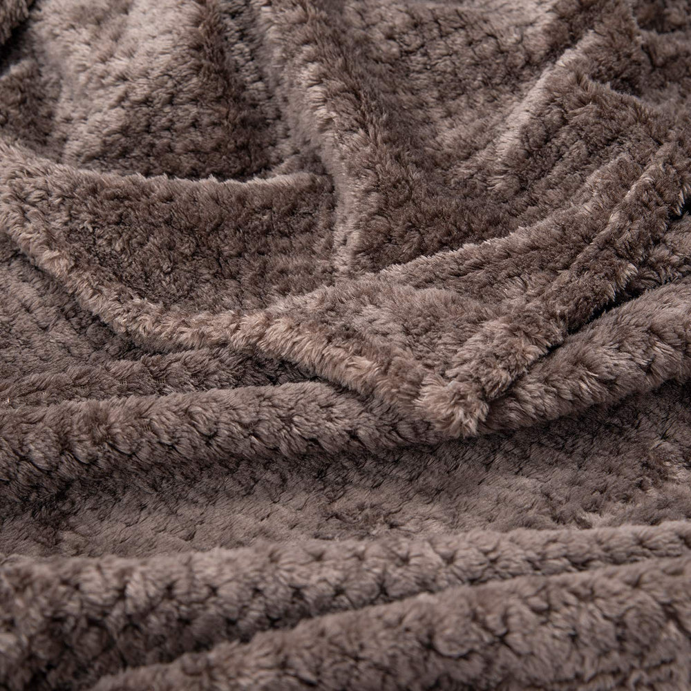 Wonder Miracle fuzzy throw blanket with a child snuggling warmly.