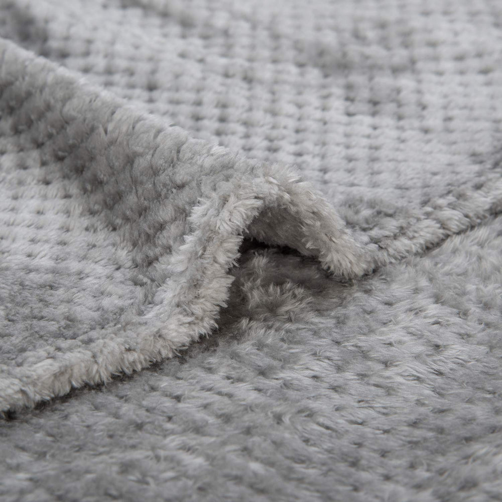 Wonder Miracle fuzzy throw blanket draped on a couch for cozy lounging