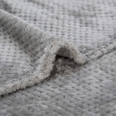 Wonder Miracle fuzzy throw blanket draped on a couch for cozy lounging