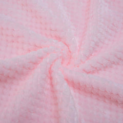 Wonder Miracle plush fleece blanket draped on bed for warm nights and relaxation.