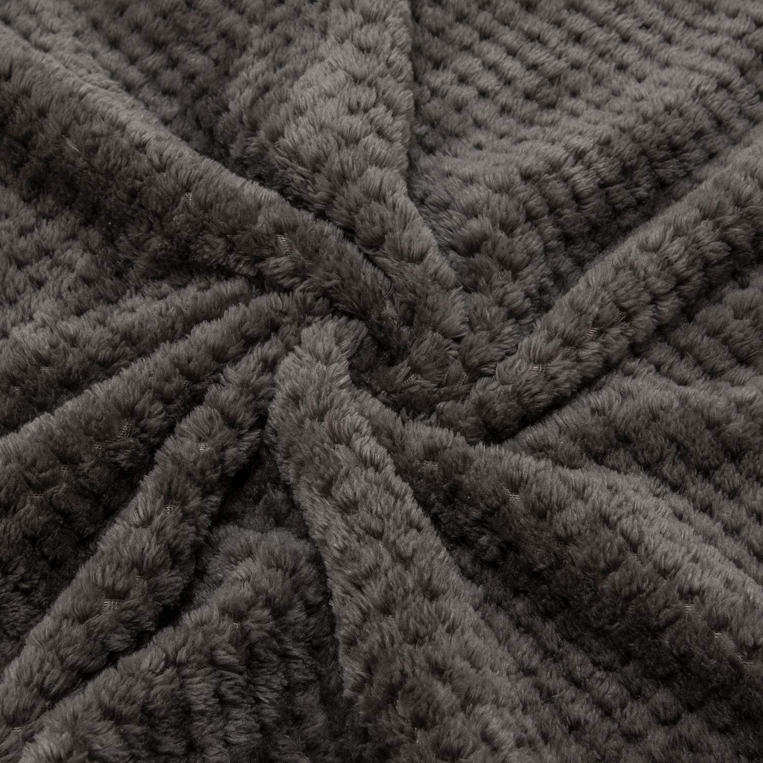Wonder Miracle fuzzy throw blanket in Eagle Grey on sofa for cozy lounging