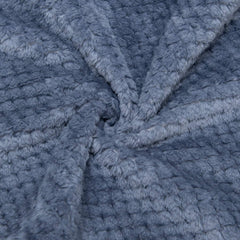 Wonder Miracle fuzzy throw blanket folded neatly, ideal for travel and portability.