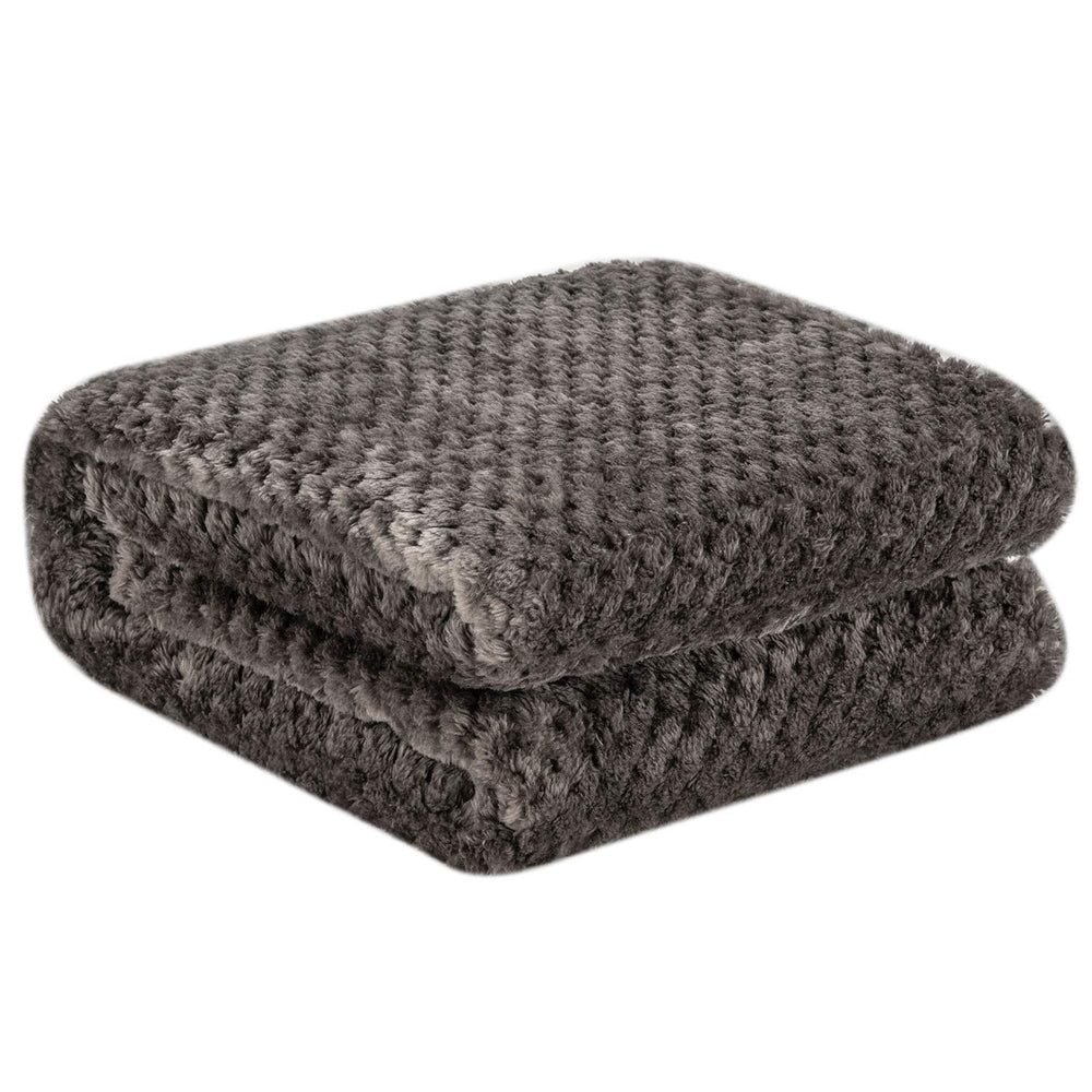 Wonder Miracle fuzzy throw blanket folded for travel demonstrates compact packability.