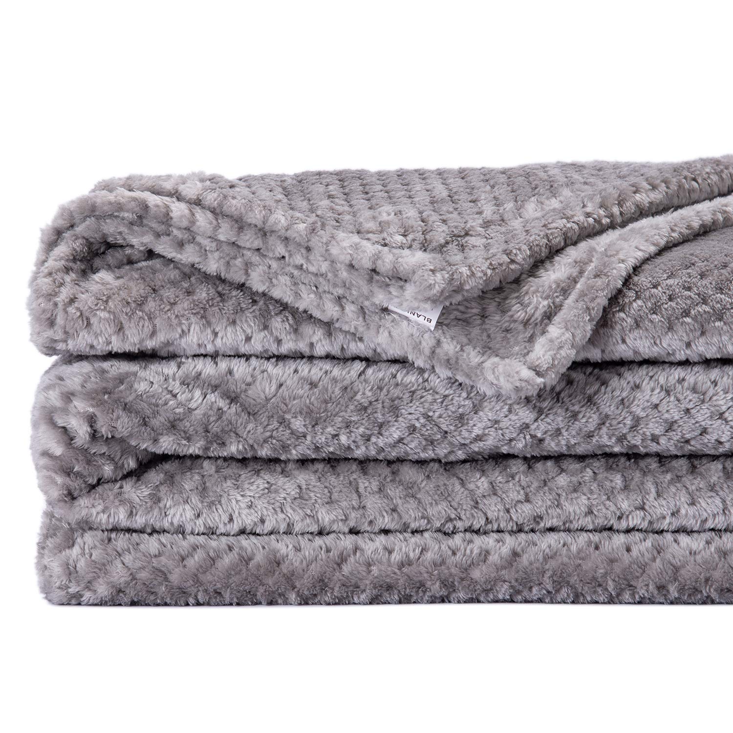 Wonder Miracle fuzzy throw blanket on a queen bed showcases size and warmth