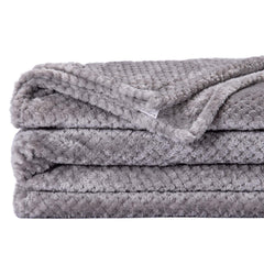Wonder Miracle fuzzy throw blanket on a queen bed showcases size and warmth