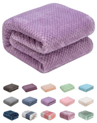 Wonder Miracle fuzzy throw blanket in lavender for cozy nights on bed or couch.