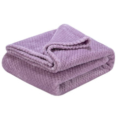 Wonder Miracle plush fleece blanket on a couch adds soft warmth for evenings.