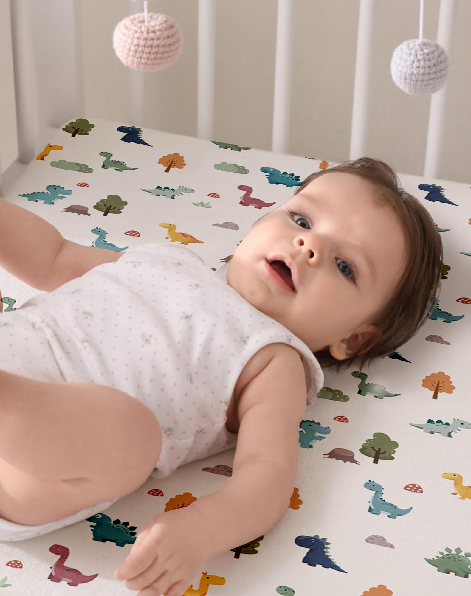 Woodiville gender-neutral Sage Dino sheets suit any nursery theme.