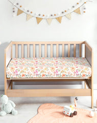 Woodiville Golden Meadow sheets on a mini crib mattress with secure fit
