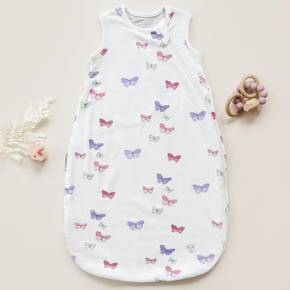 Baby wearing Woolino sleep sack in crib for secure warmth
