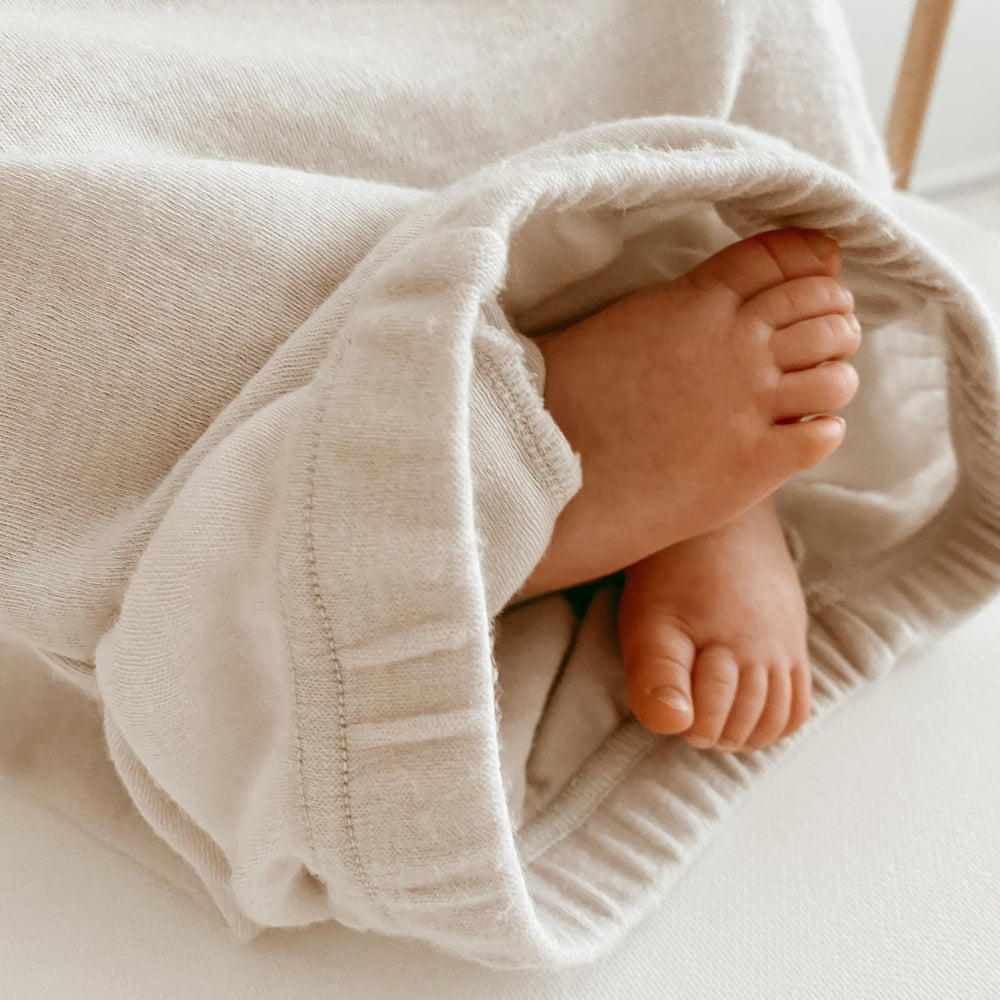 Woolino infant nightgown beige color highlights Merino warmth and breathability.