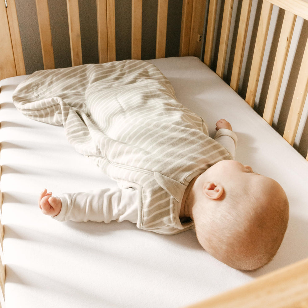 Woolino Merino sleep bag full view on bed emphasizes calm design.