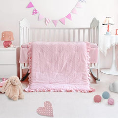Wowelife comforter close-up shows pink ruffles and soft texture