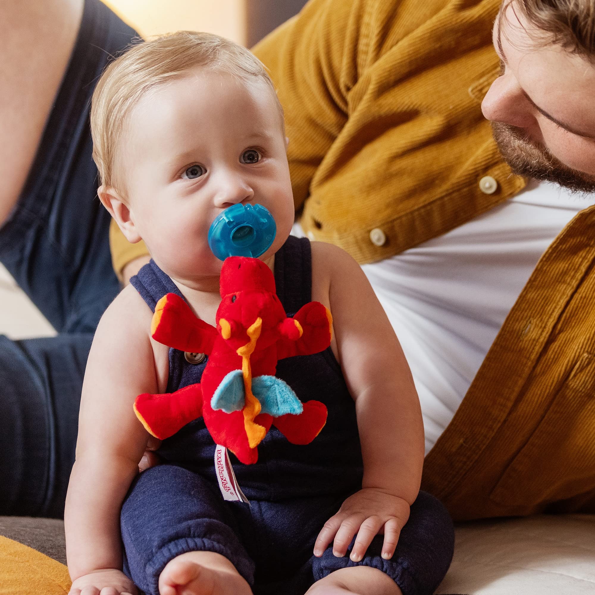 WubbaNub matching red dragon lovey with pacifier for comforting companionship.