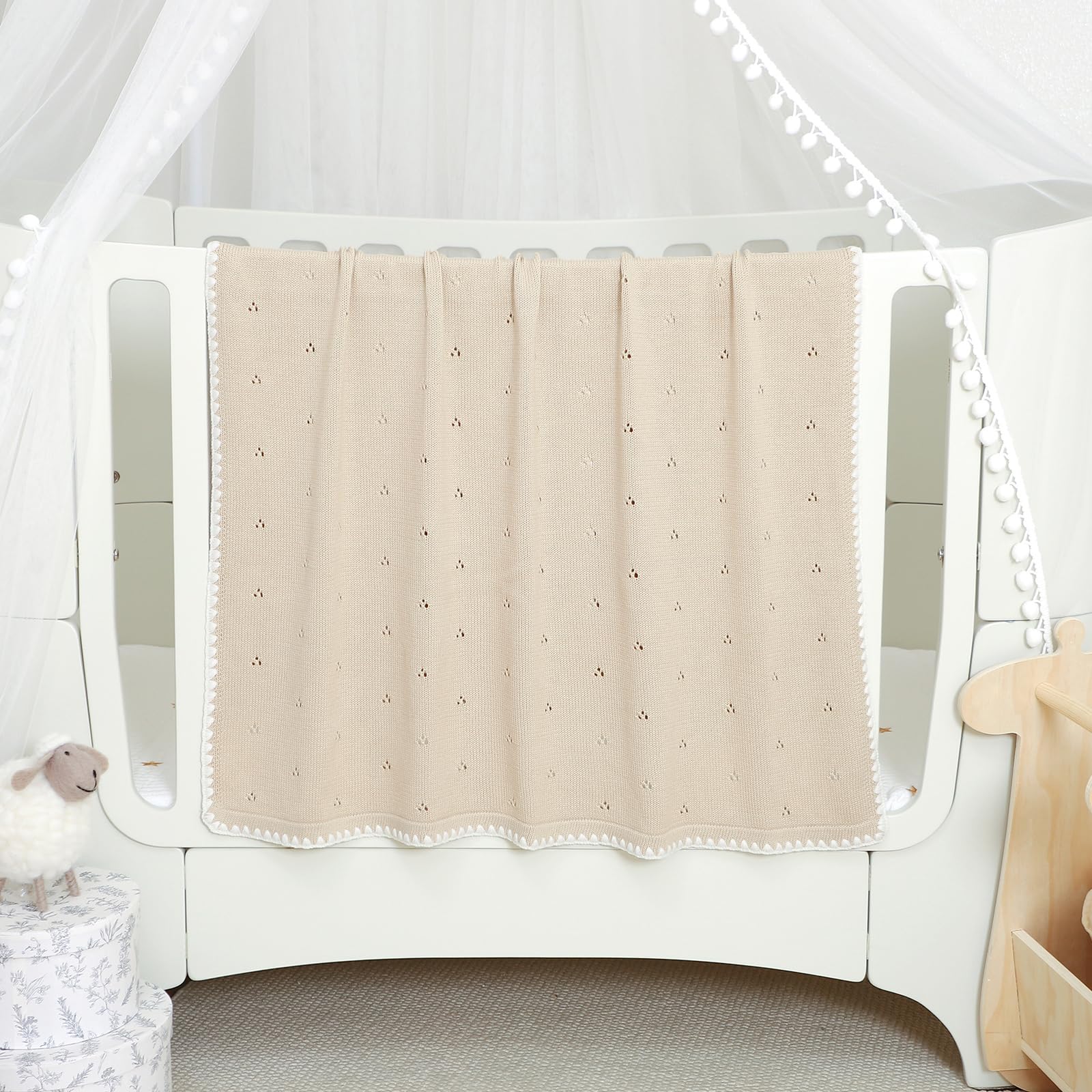 Wugugu nursery design knit blanket coordinates with crib and bassinet themes.