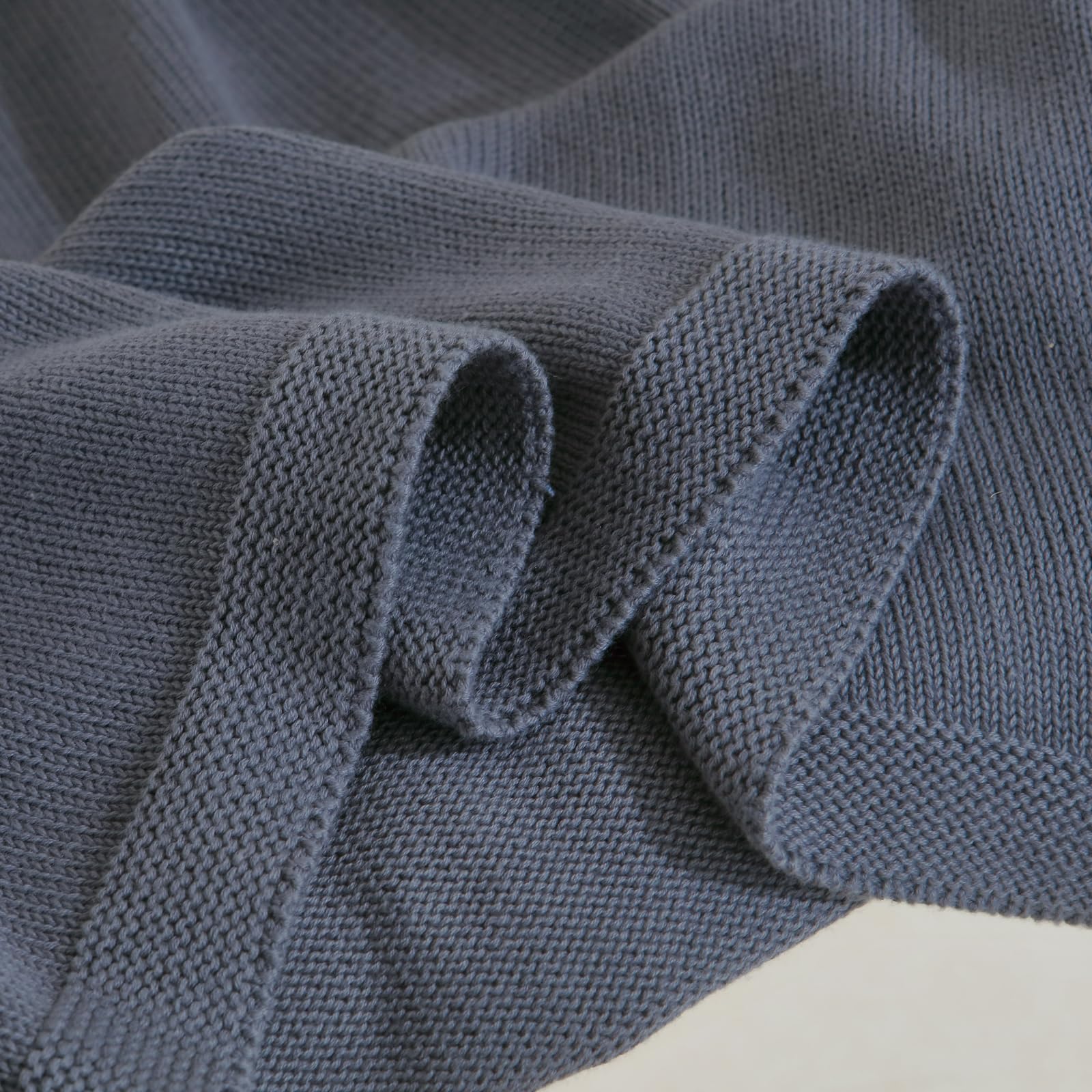 WZOWZO knit baby blanket folded flat for compact storage.