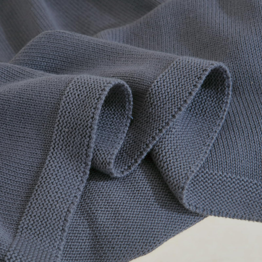 WZOWZO knit baby blanket folded flat for compact storage.