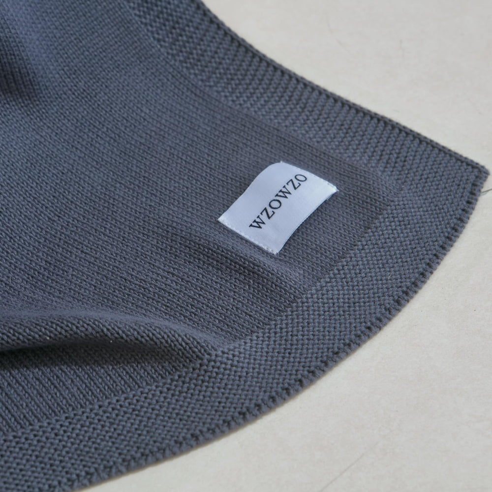 WZOWZO knit baby blanket draped on crib for cozy naps.
