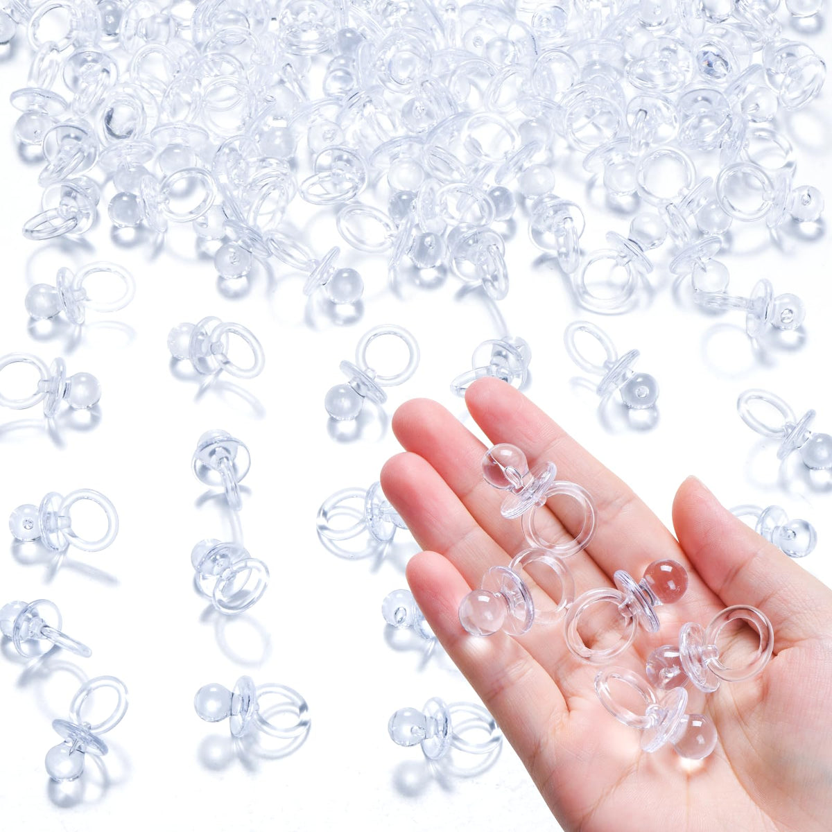 XINHUIDALSQ mini pacifiers close-up, clear acrylic decor for baby showers and favors.