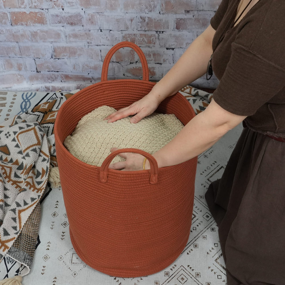 XUANGUO rust-red cotton rope blanket storage basket holding throws neatly.
