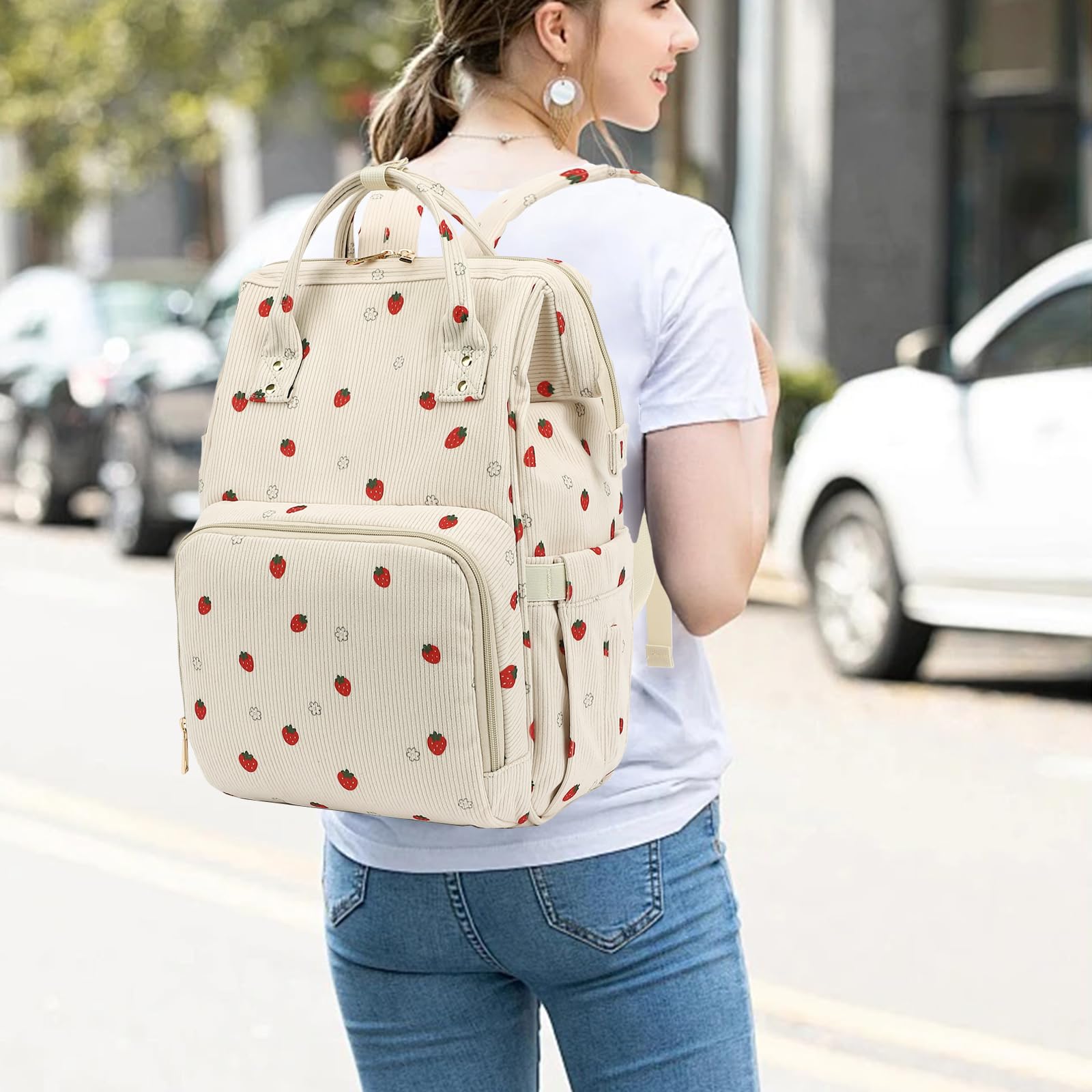Xunteny corduroy diaper bag backpack side pockets keep bottles and tissues within quick reach.
