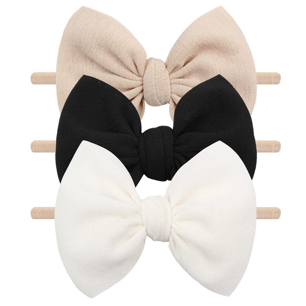 YanJie 3pc soft headbands in black, white, beige with bows for versatile baby outfits.