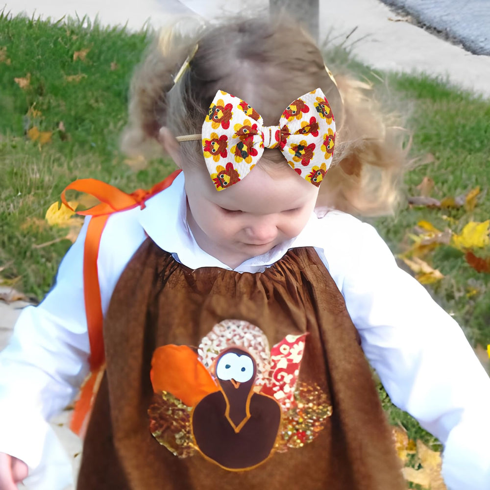 YanJie pumpkin print bow pairs with fall outfits and family photos.