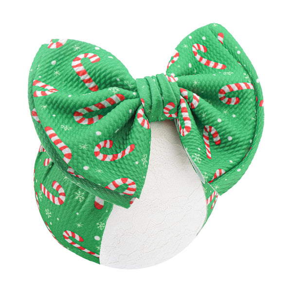 YanJie candy cane headband, 7-inch green bow, soft waffle fabric for gentle comfort at holiday events.