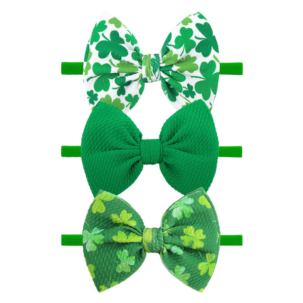YanJie St. Patrick's Day headband with green bows for adorable newborn photos.