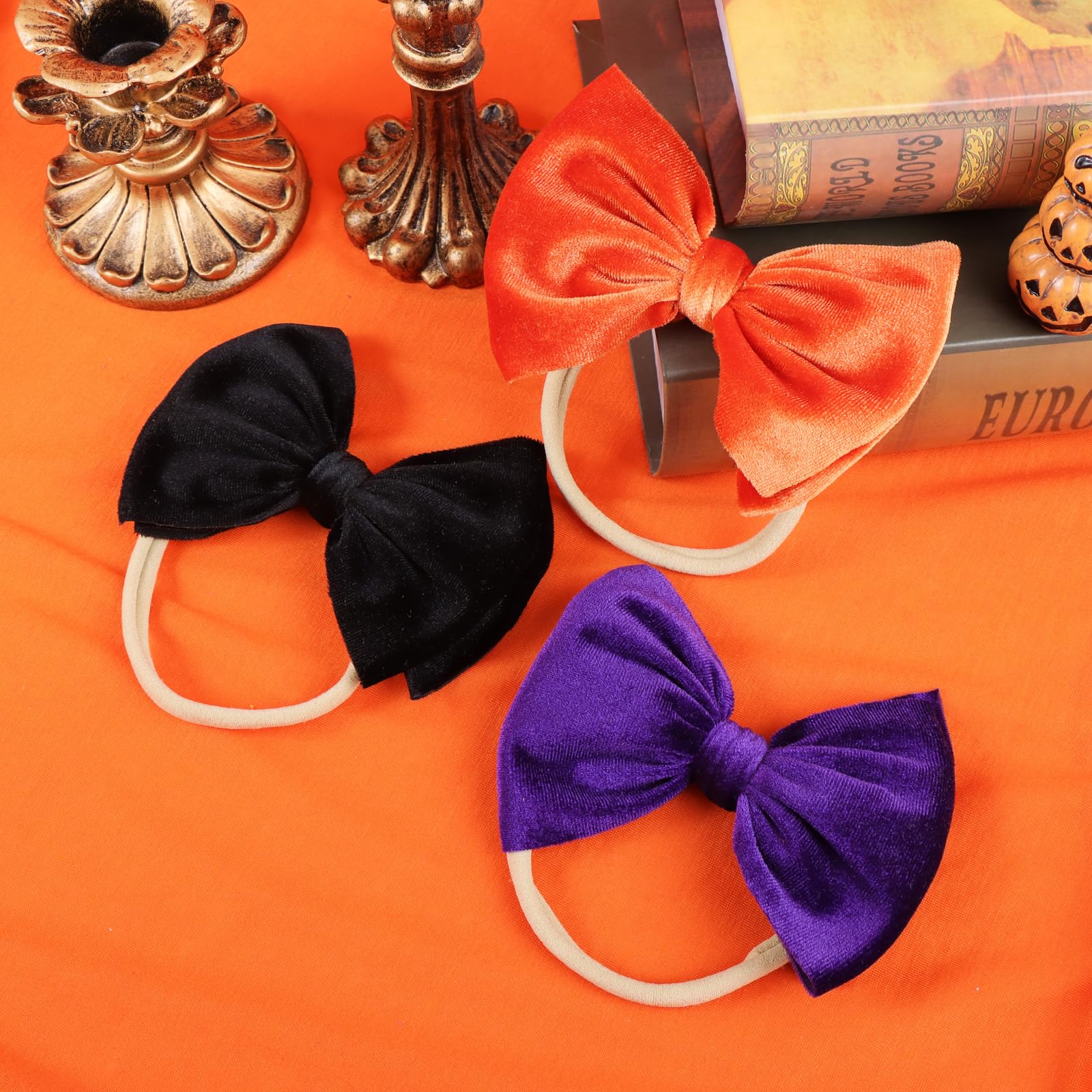 YanJie velvet bow headband black, secure elastic fit for newborns.