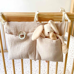 YeeMan cotton baby bedside bag in oatmeal hangs on crib for convenient storage.