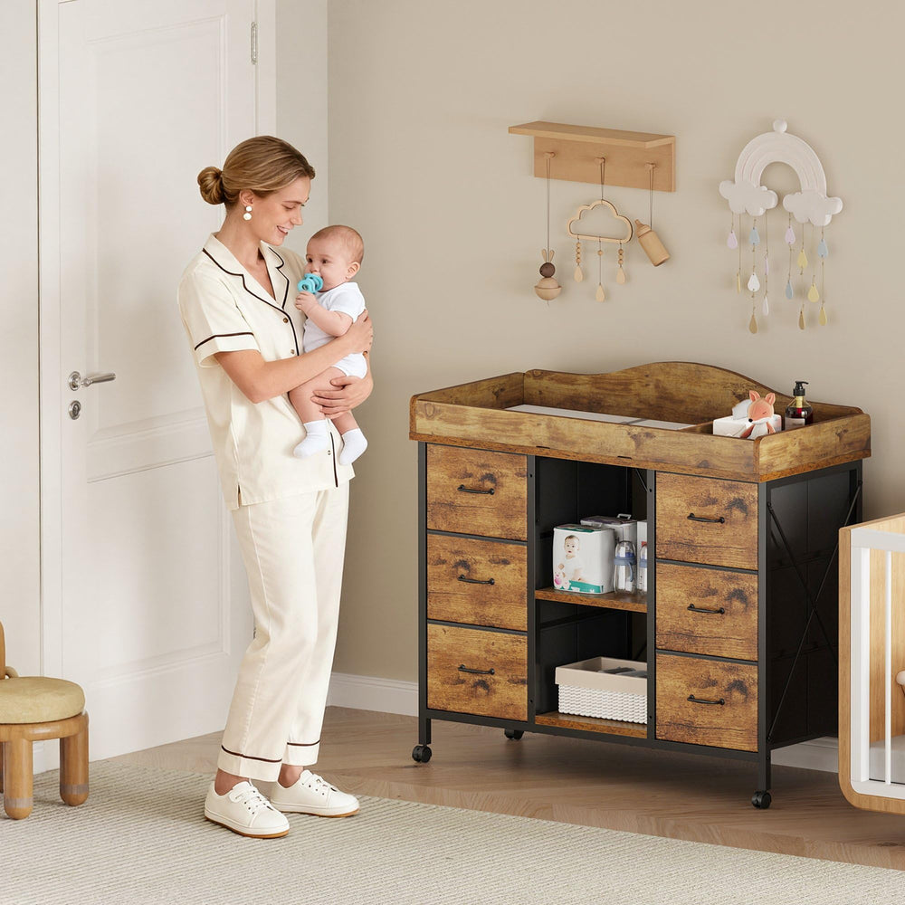 YeTom Yetom 6-drawer dresser beneath the changing table for ample storage.