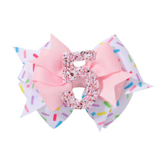 YHXX YLEN pink number-5 birthday bow adds festive sparkle to a girl's hairstyle.