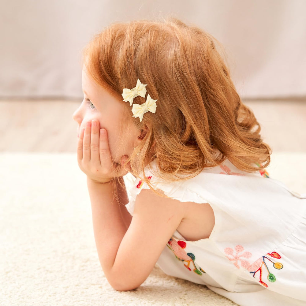 YHXX YLEN tiny grosgrain bow pair; versatile daily accessory.