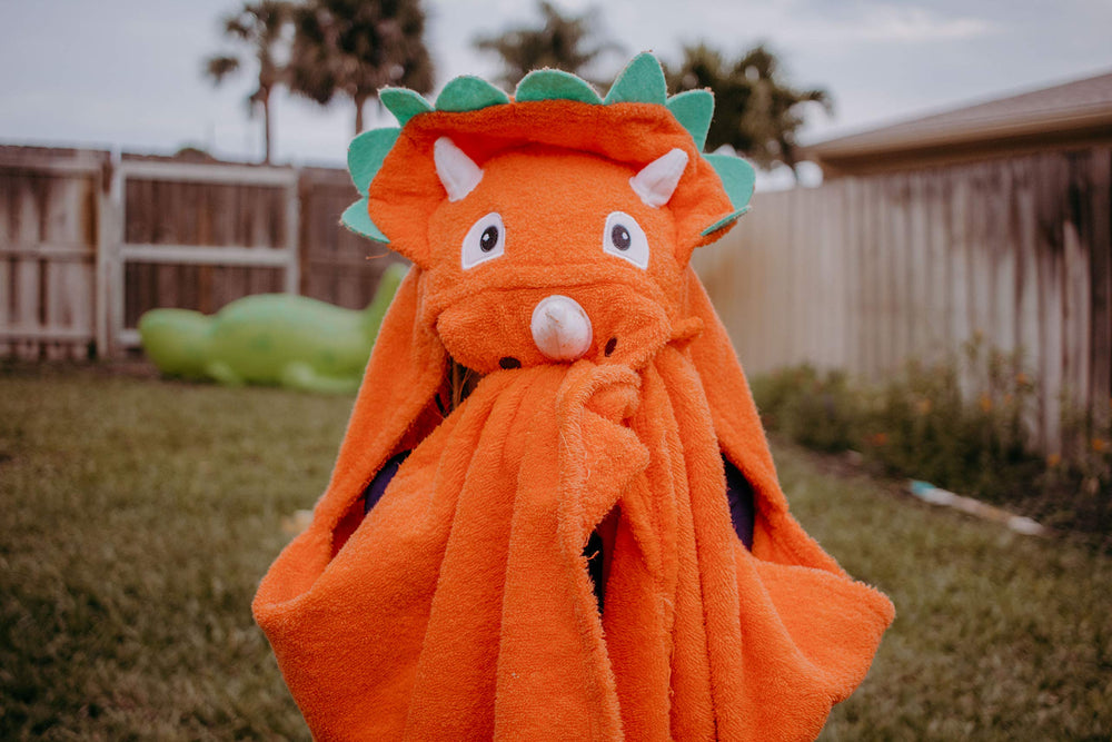 Yikes Twins hooded dino towel pocket closure shows robe-like handling.