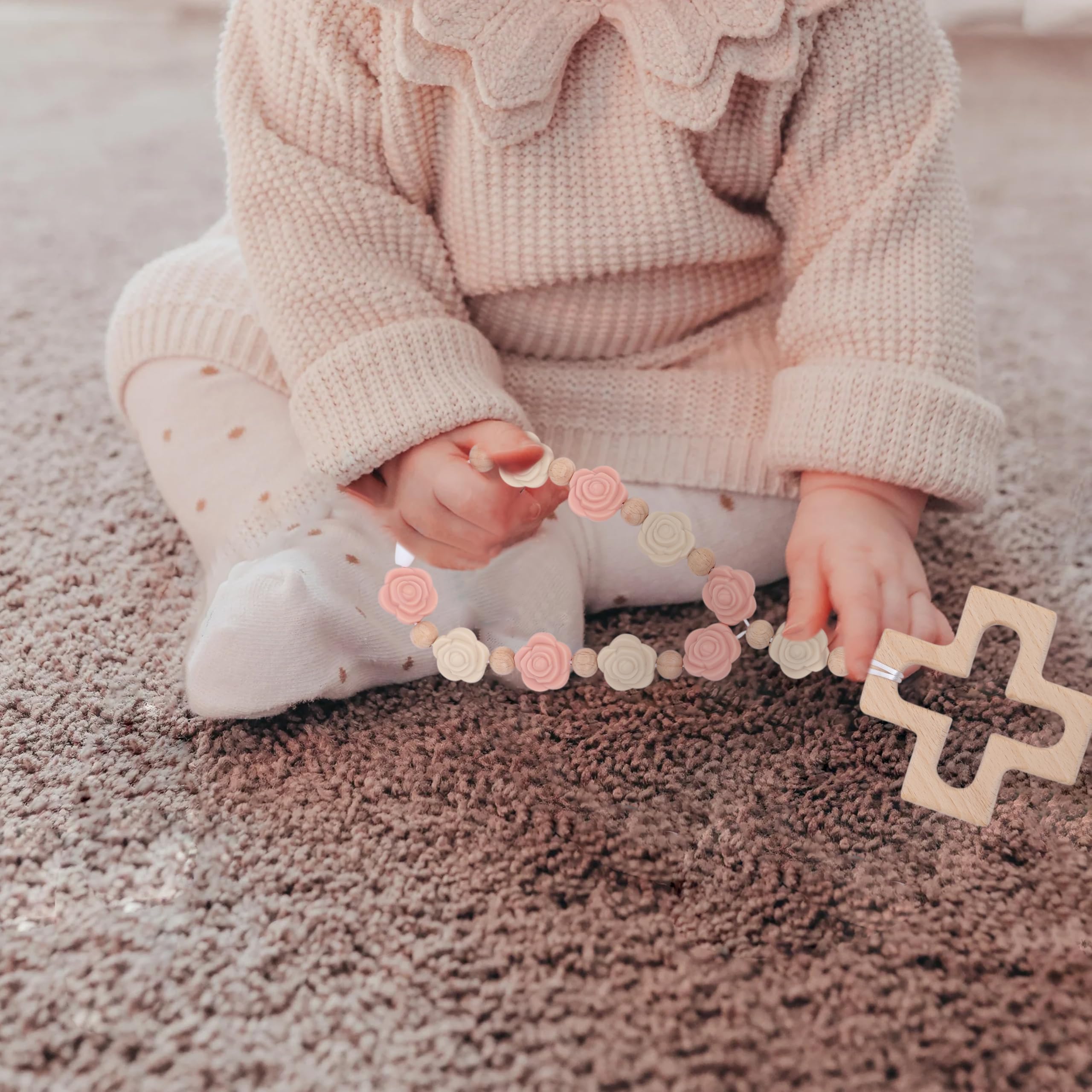YOUAME pale pink rosary enhances baby shower decor with tactile charm.