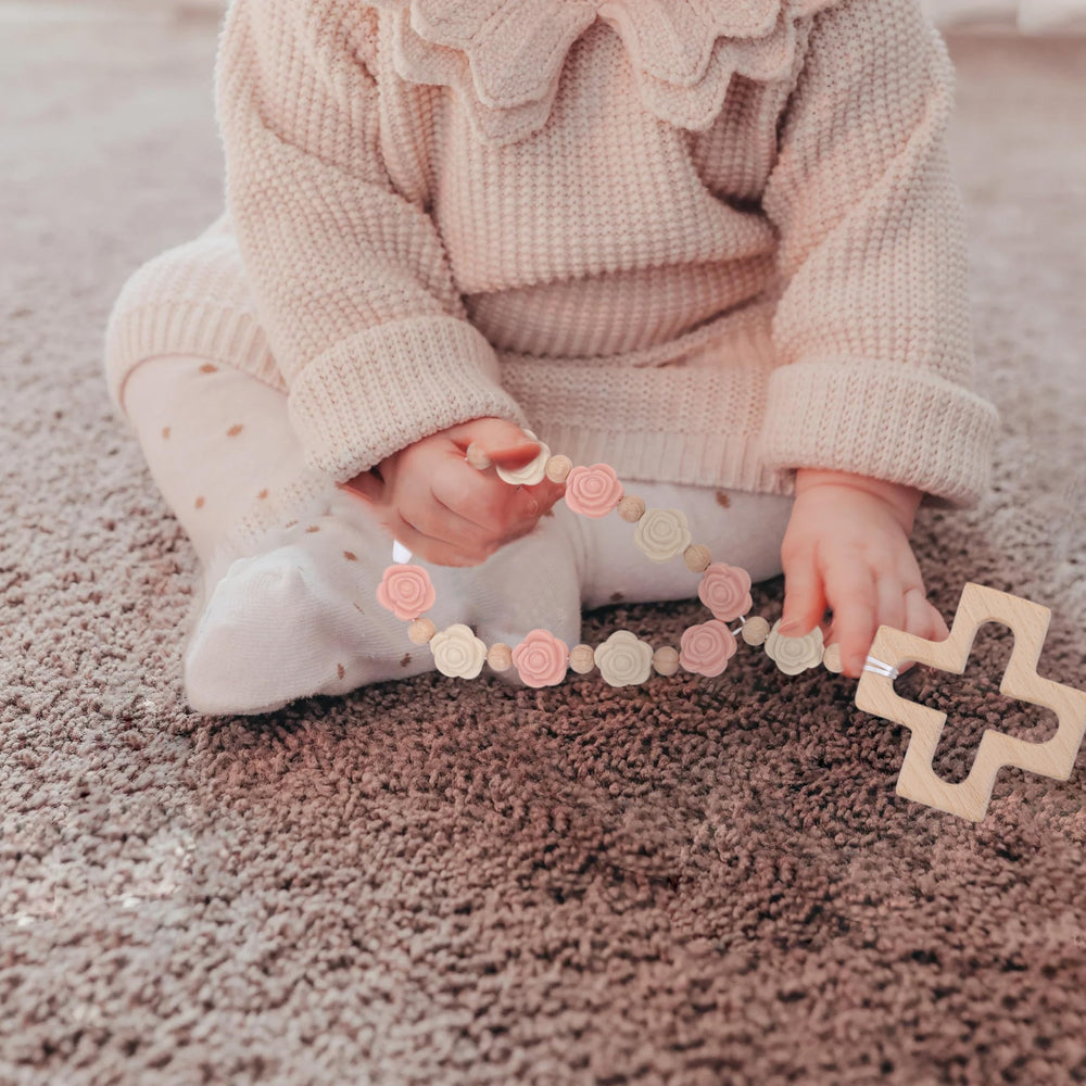 YOUAME pale pink rosary enhances baby shower decor with tactile charm.