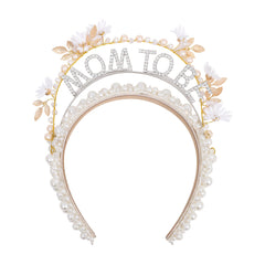 YOUAME pearl-embellished mom-to-be headband close-up with fabric flower and gold accents