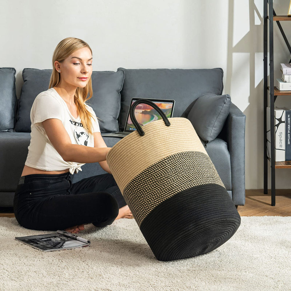 YOUDENOVA tall laundry hamper in bedroom with blankets and towels
