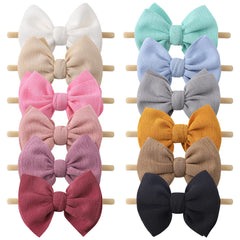 Yoyokid 12-piece bow headbands on a soft nylon band for gentle daily wear.