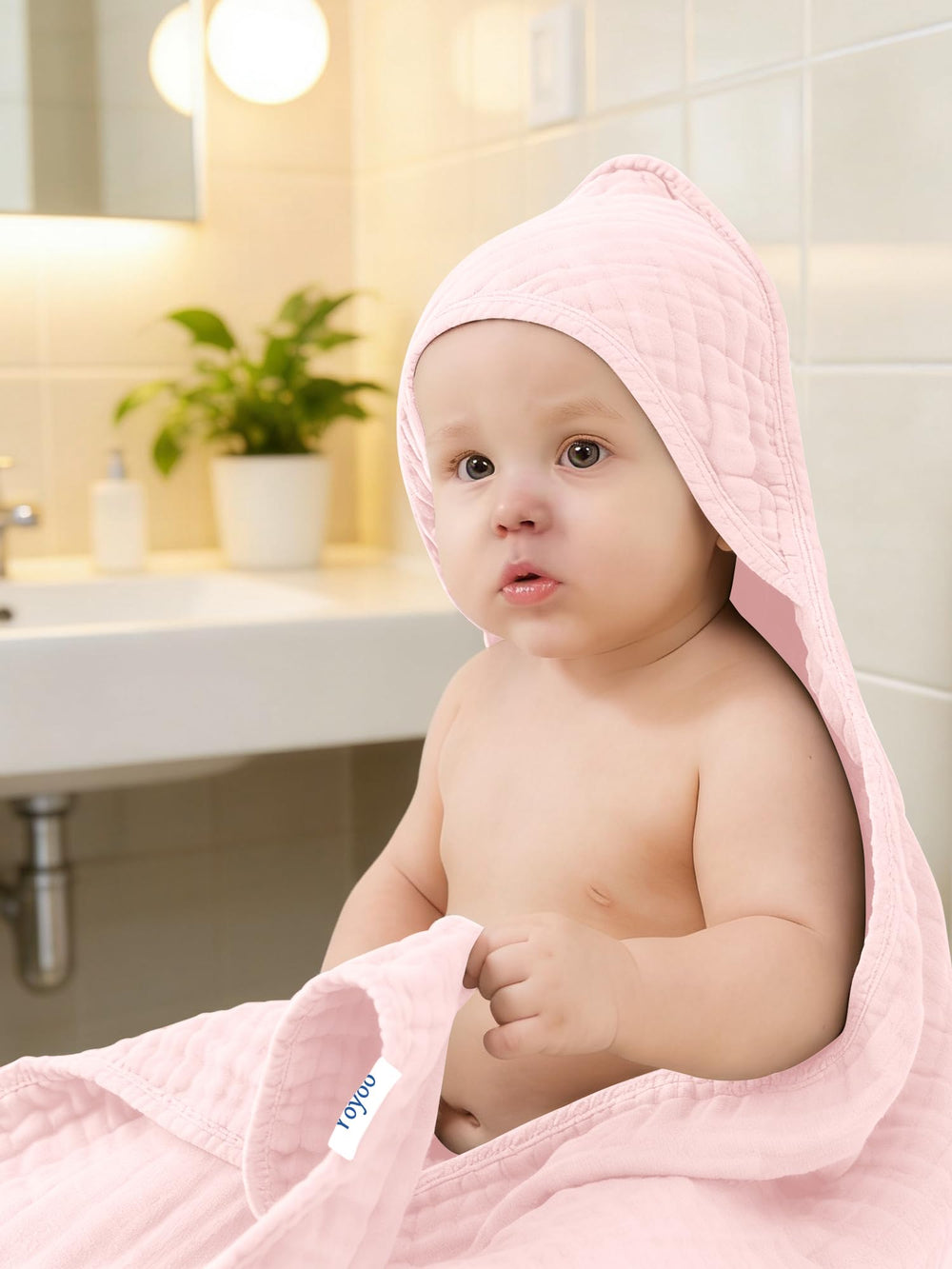 YOYOO bath-time pink towel rolled for easy packing.