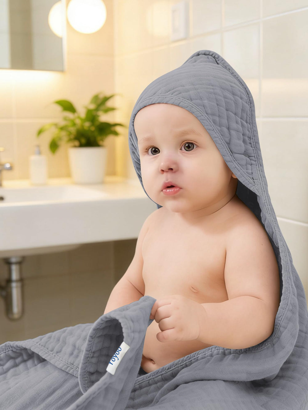 YOYOO towel demonstrates multi-use as swaddle or changing mat cover.