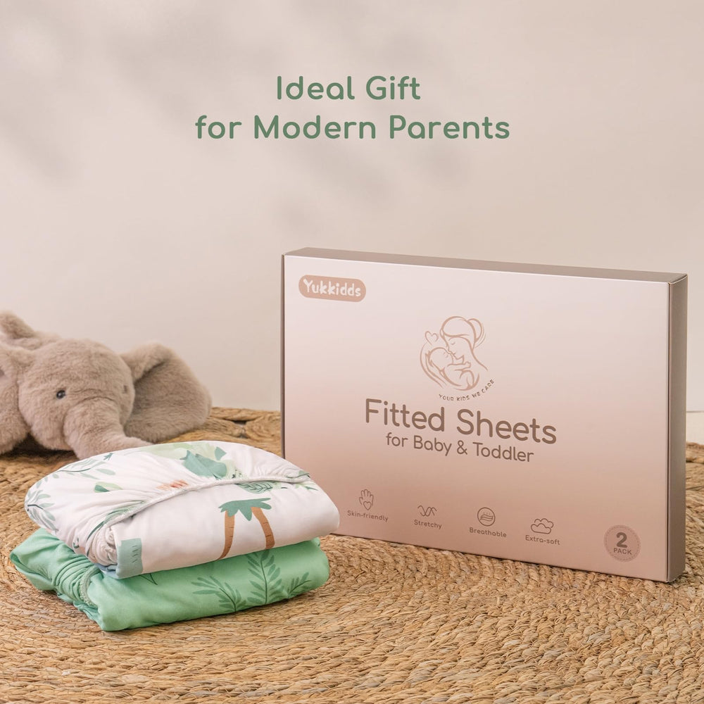 Yukkidds two-pack mini crib sheets displayed in tidy setup