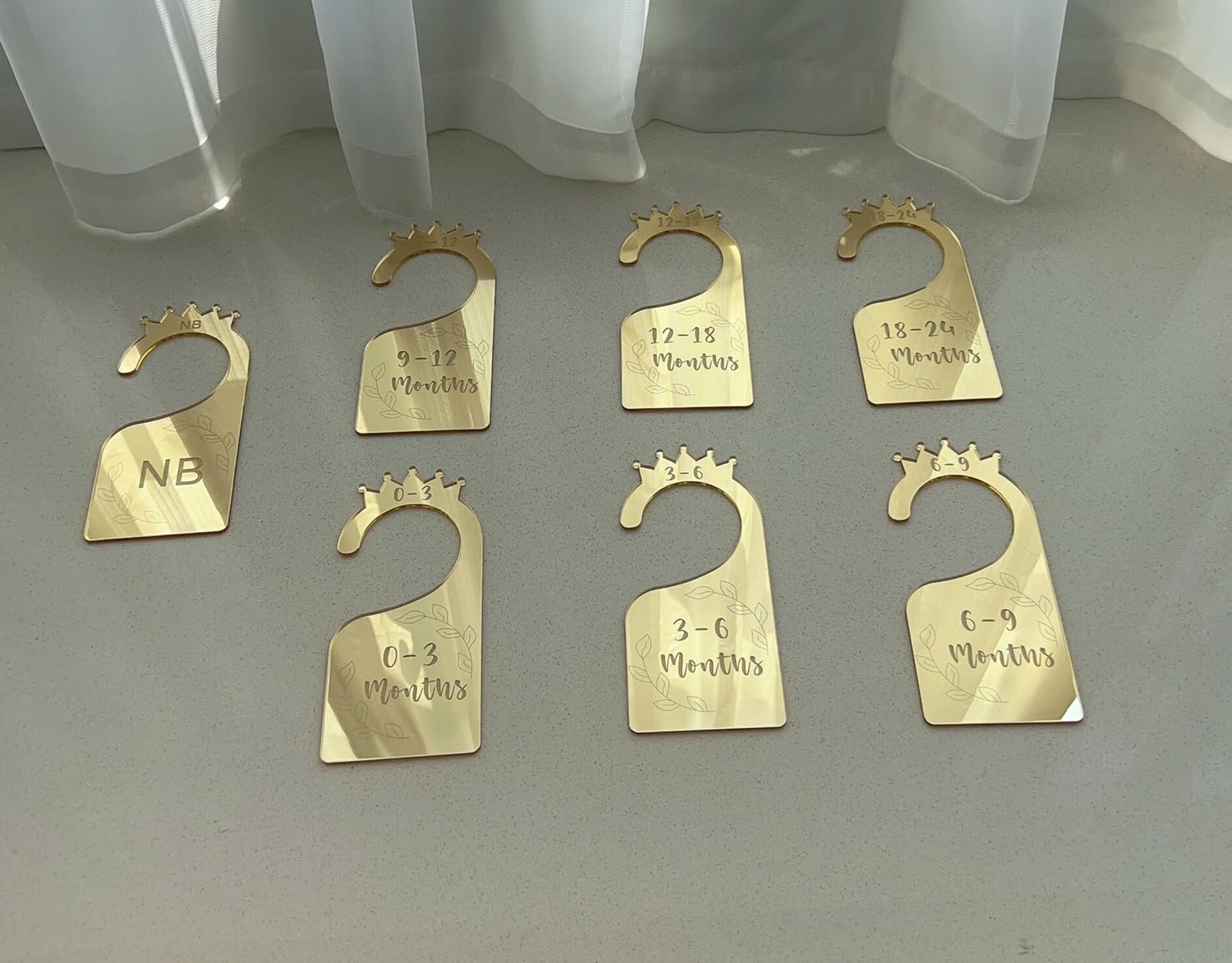 Yuxuanish seven-piece baby closet dividers set on a rod for easy organization.